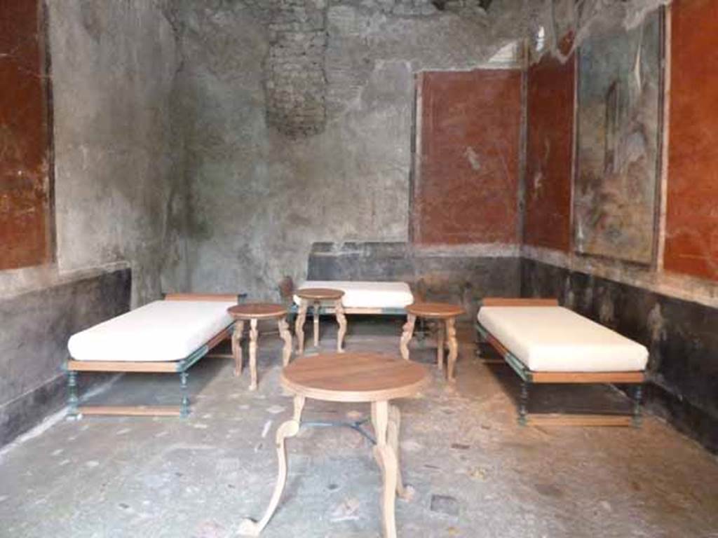 IX.13.1-3 Pompeii. May 2010. Room 13, with reproduction dining furniture, looking north.