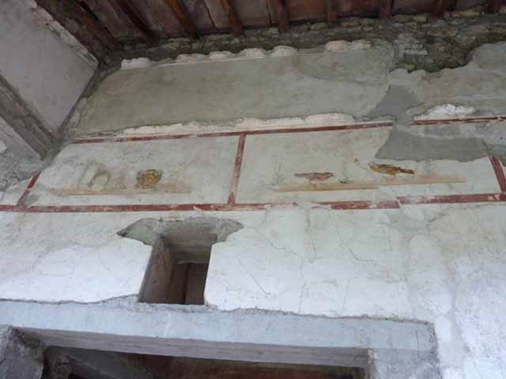IX.13.1-3 Pompeii. May 2010. Room 9, upper level on north wall of north portico, above the doorway to room 12.