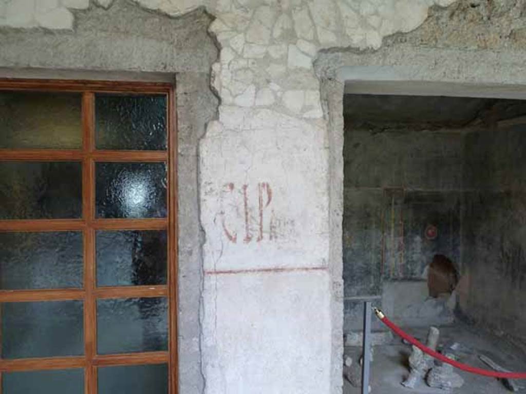 IX.13.1-3 Pompeii. May 2010. Room 9, south wall with painted graffiti between window of room 14, and doorway to room 15.