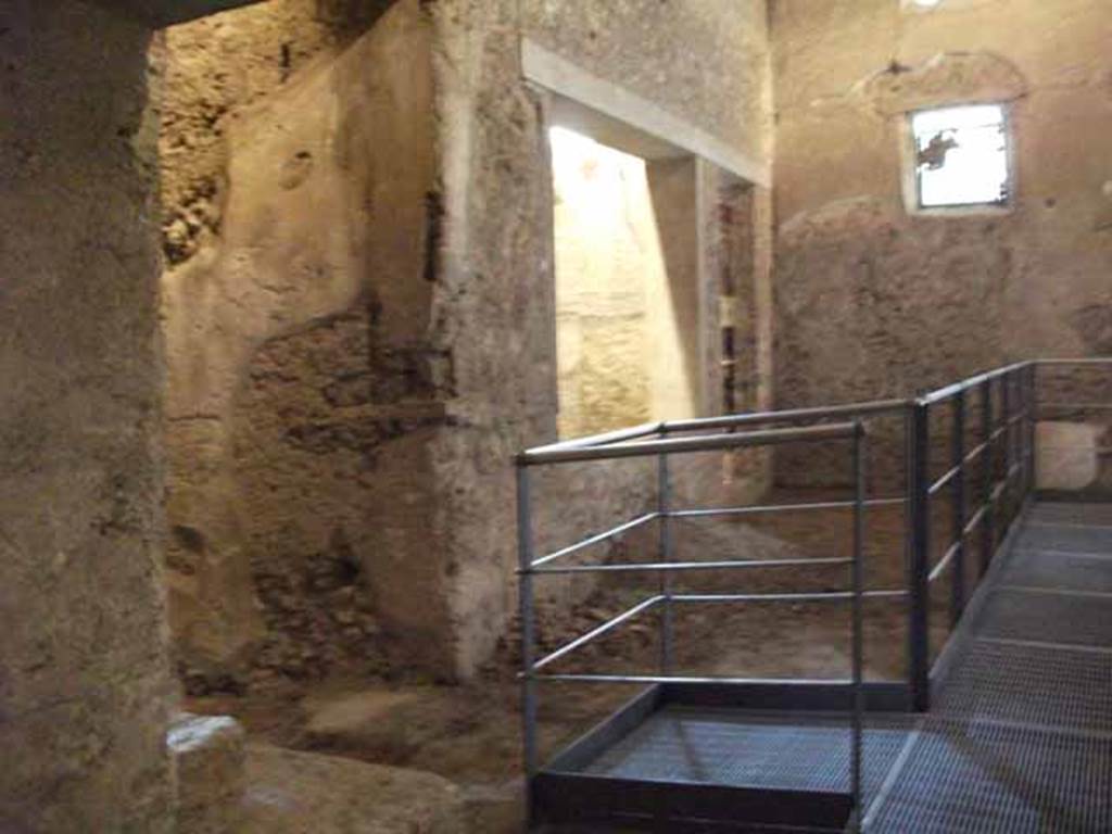 IX.13.1-3 Pompeii. May 2010. Room 31, looking west, south side with corridor leading to IX.3.1, on the left.