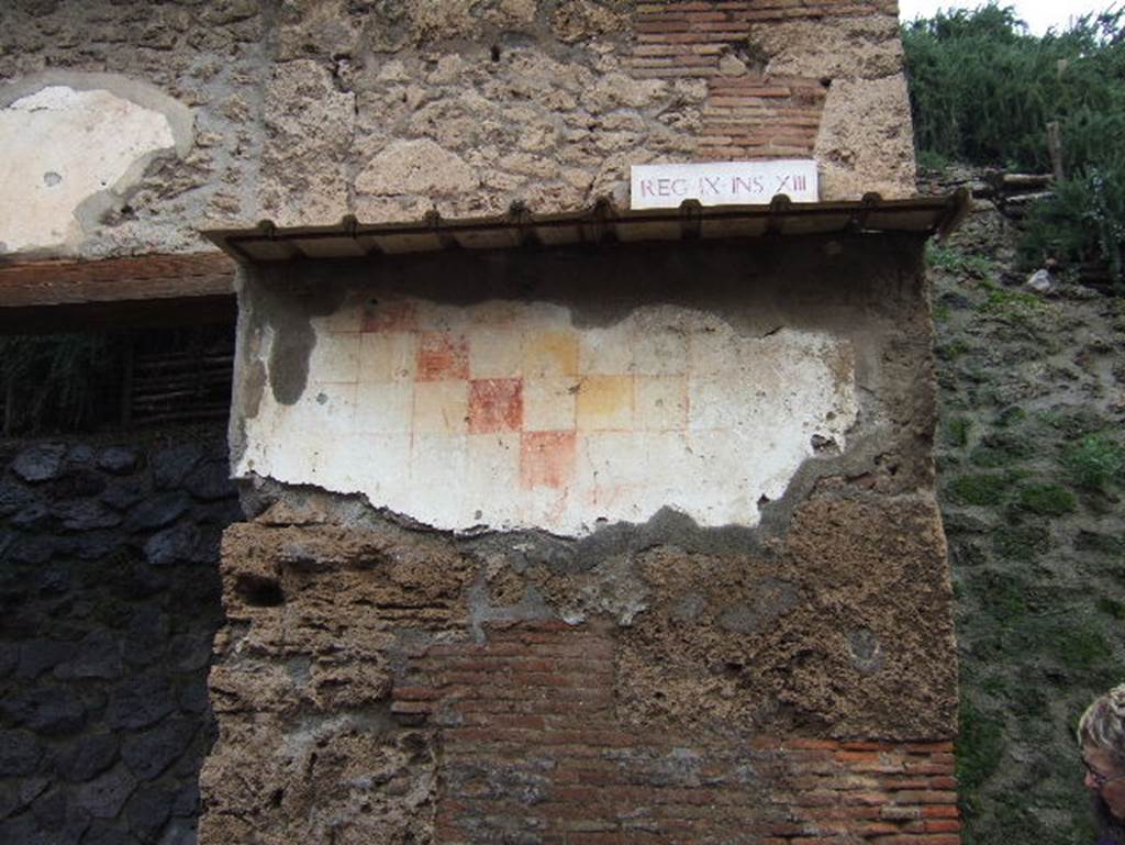 IX.13.6 Pompeii. December 2005. Plaster with chessboard pattern to east of entrance.