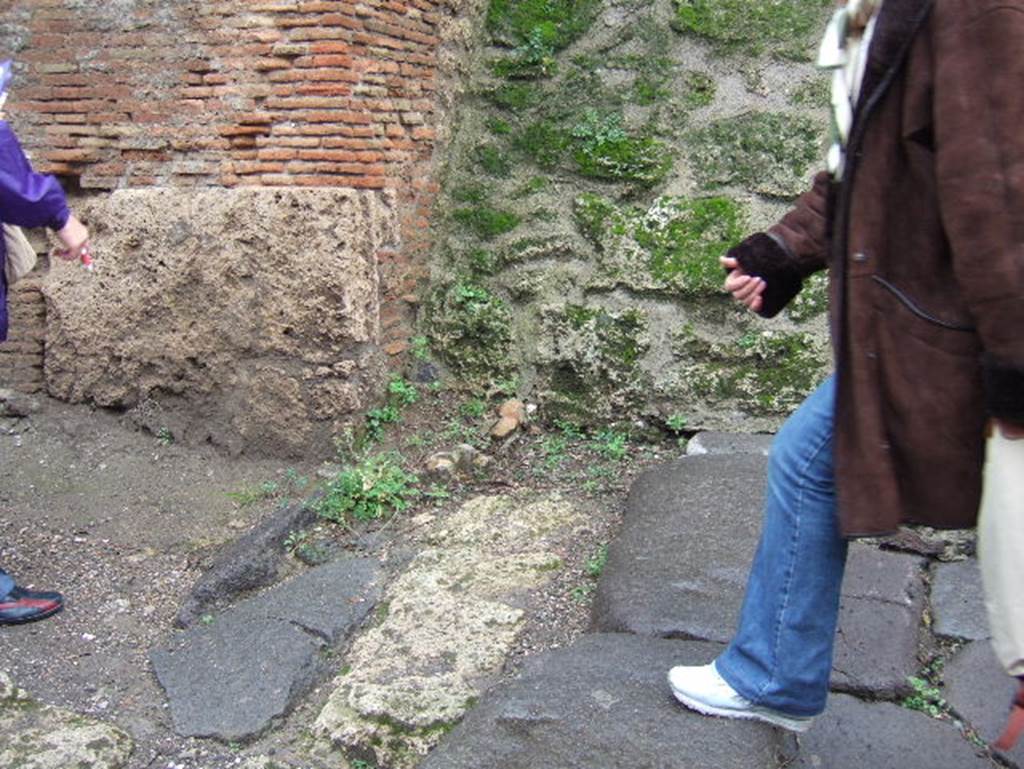 IX.13.6 Pompeii. December 2005. East corner of insula. On this corner used to stand an amphora with its top half removed (Amphora Urinaria).
This was to receive the urine of passers by, for the use of the fullers or fullones. According to Della Corte, found immediately at the turn into the eastern vicolo at the corner of the insula, was a terracotta amphora.
This had been conserved in situ from the time of excavation, (the end of April 1913). It had been restored from broken pieces, but with a broken rim since antiquity. This was an example of a (Urinarium) gastrum.
It would have been placed there by the fuller Fabius Ululitremulus, to collect the urine of passer's by for his industry’s use. The urine was used as a bleach as part of the cleaning process. See Della Corte, M., 1965. Case ed Abitanti di Pompei. Napoli: Fausto Fiorentino. (p.338)
See amphora in situ in SAP photo C 753 (=D80935) taken about 1915, shown in See Varone, A. and Stefani, G., 2009. Titulorum Pictorum Pompeianorum, Rome: L’erma di Bretschneider, (p.471)