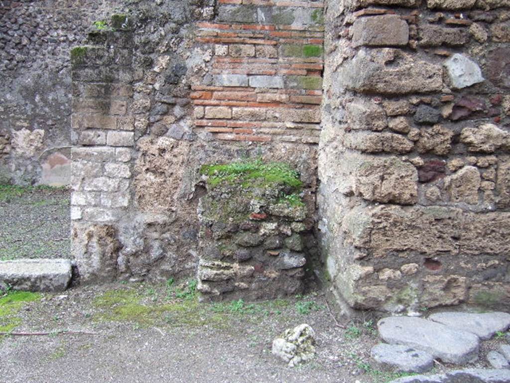 Street altar outside front wall of IX.14.1. December 2005. The support of the modern bridge is on the right.