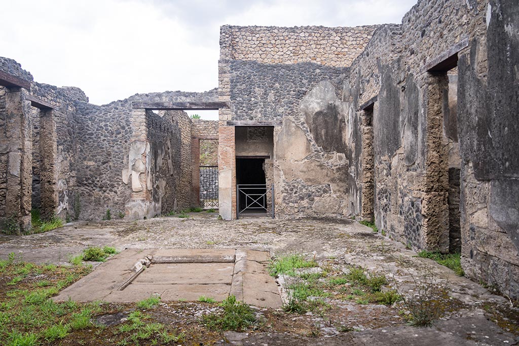 IX.14.4 Pompeii. July 2024.
Looking north across secondary atrium 27 at IX.14.2 towards entrance doorway. Photo courtesy of Johannes Eber.