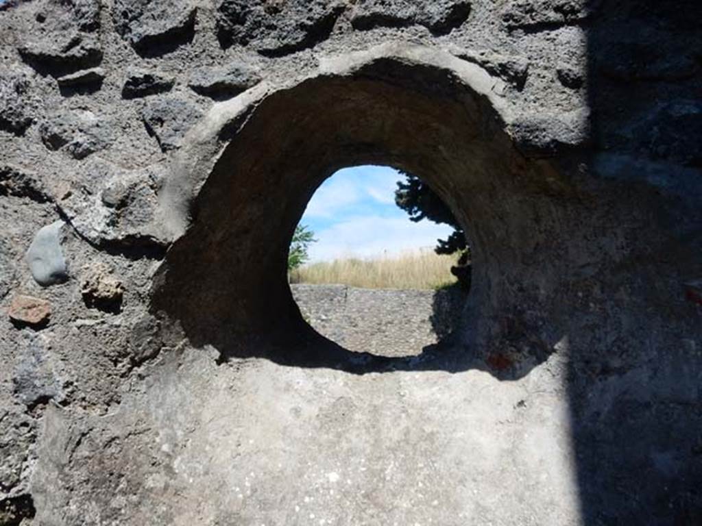 IX.14.4 Pompeii. May 2017. Looking east through circular window above latrine in room 8. Photo courtesy of Buzz Ferebee.