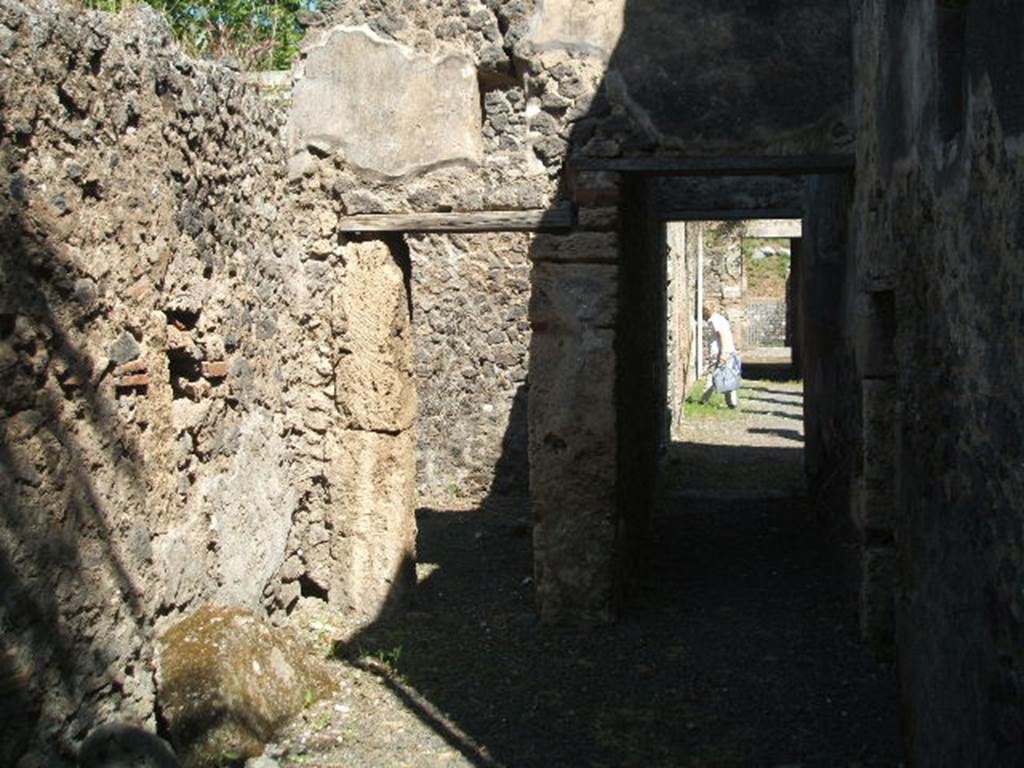 IX.14.4 Pompeii. May 2005. Looking north through corridor in south west corner of house.
The doorway to room 11 is on the left.