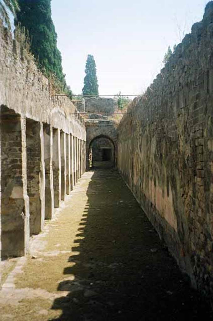 HGW24 Pompeii. July 2010. Looking east along south portico from south-west corner.
Photo courtesy of Rick Bauer.
(Fontaine, No. 18 was found near room 5,2, in south-west corner of garden portico).
From PAH, addendum, p.122 –
Relazione delle antichita, che si vanno ritrovando nella masseria del sig. D. Giovanni Milano parsonaro, che si era principiata al di 14 Febbraro 1771. (Report of Antiquities found.....)
“No.18. A di 22 agosto 1771. Si e trovata una piastra come la descritta per uso di porta, ed e rotta in due cantoni; e tra la terra di quella vicinanza so sono trovate due monete di bronzo di diam. quasi uguali, on. 1 vantaggiata; in una vi e una testa circondata da iscrizione, e dal lato opposto S.C; ;’altra non si distingue per la ruggine.”