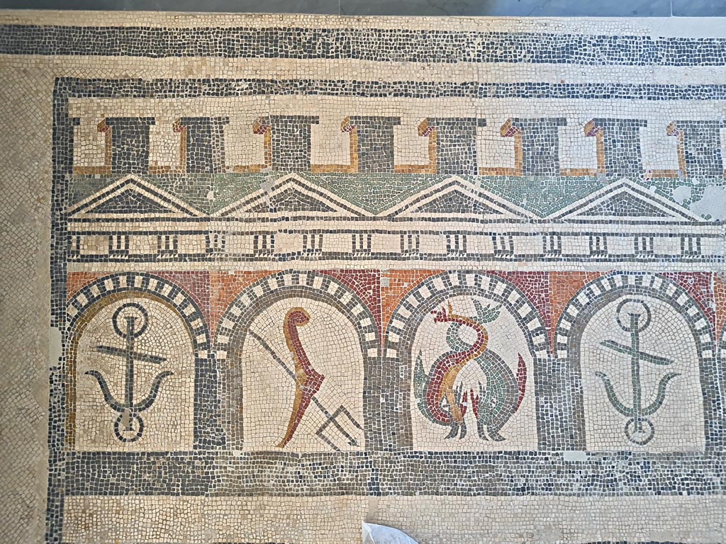 Villa of Diomedes ? or VI 17.10 Pompeii ?. June 2024.
Detail from mosaic of “doors”, starting with an anchor, trident, two dolphins, an anchor, one dolphin, and a stern of a ship with rudder.
On display in Naples Archaeological Museum, Room CXXXIV. Photo courtesy of Giuseppe Ciaramella.