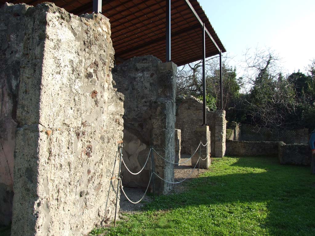 HGW24 Pompeii. December 2006. Looking south along terrace from near the room with window.
The doorway to the tablinum is hardly visible, on the left.
“No.3 on the La Vega plan was found in the tablinum on 20th February 1771. This room was decorated with various paintings on a red background, and seen were landscapes, houses in the countryside, baskets with figs, and others: the zoccolo/plinth was black with pretty decorations. The floor was of crushed brick (mattoni pesti), with some white stones used as a mosaic. In the frieze of this room (“at the height of the frieze??”) the vase numbered 1 on the plan by La Vega was found.”