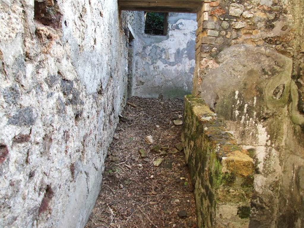 HGW24 Pompeii. December 2006. Looking south along east end of corridor at the side of the stairs to cellar level.
According to the plan by La Vega, No.81 was found in the above corridor, but there were two No.81’s shown.
The one shown on PAH addendum, p.160 – dated 25th June 1774 would seem to fit in with the dates when the surrounding rooms were excavated – but no further details are shown.
(The other No.81 would seem to be from 7th or 9th December 1773, and from the west side of the cellar below the garden area, and said –
From PAH, addendum, p.131 –
Relazione delle antichita, che si vanno ritrovando nella masseria del sig. D. Giovanni Milano parsonaro, che si era principiata al di 14 Febbraro 1771. (Report of Antiquities found.....)
“No.81. nella stessa date. Si e ritrovata una sciva di bronzo, e tra la terra levata di quel sito si sono trovate tre monete, due di diam. on.1, e l’altra di min. 3 ½ , che per la ruggine non si distinguono. Un pezzo di sciva, il tutto di bronzo. Ed un bottone di vetro.”