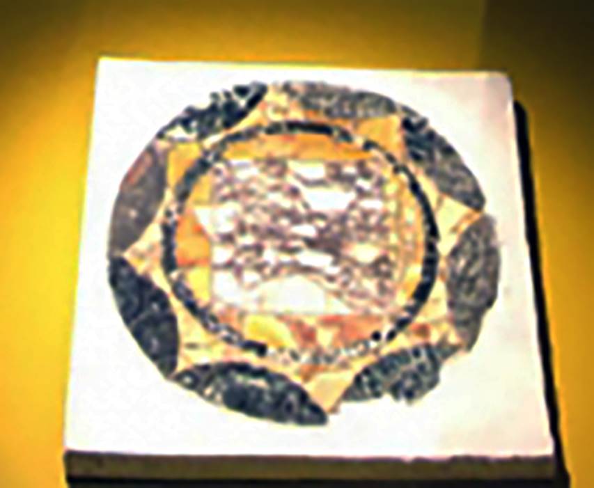 Villa San Marco, Stabiae. Room 16, round section of opus sectile floor tile.
Stabia Antiquarium, inventory number 63778.
According to Bonifacio, this is the same as tile 62545 but with a different design.
The tiles were made from shaped marble pieces of various colours and textures, assembled, cut and polished to compose a variety of geometric designs.
Floors of this type being quite costly, were reserved for the most important rooms of a villa.
See Guzzo P., Bonifacio G. and Sodo A.M. (a cura di), 2007. Otium Ludens: Stabiae - at the heart of the Roman empire. Hermitage Museum. Stabia: Nicola Longobardi, p. 129.