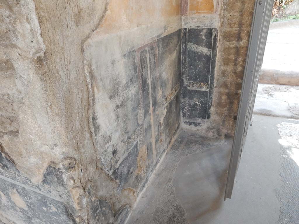 Villa San Marco, Stabiae, June 2019. Room 44, black painted zoccolo on east side of entrance doorway.
Photo courtesy of Buzz Ferebee.