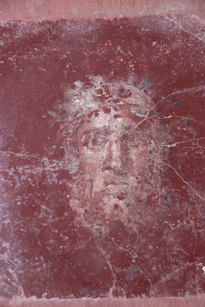 Villa San Marco, Stabiae, September 2019.
Room 44, detail of painted face from east wall in south-east corner. Photo courtesy of Klaus Heese.