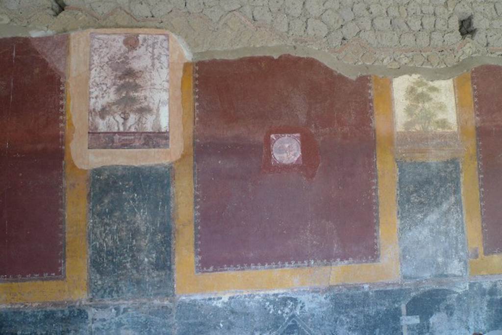 Castellammare di Stabia, Villa San Marco, July 2010. Room 20, east wall.
As part of the improvements to the villa, photo reproductions of some of the frescoes have been added to the wall. The reproduction fresco top left has a head of Medusa (upper) a tree and a Nile scene (lower) with an edifice with two temple-like side wings and a crocodile. This replaces one now in Naples Archaeological Museum, inventory number 8511.
The reproduction medallion of a villa in maritime setting (centre) replaces one now in Naples Archaeological Museum, inventory number 9409D.
Photo courtesy of Michael Binns.