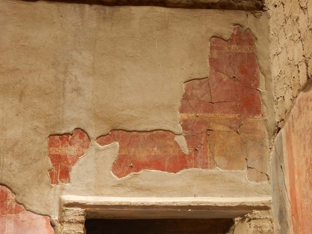 Villa San Marco, Stabiae, June 2019. Room 25, detail of painted decoration above doorway in west wall in north-west corner.
Photo courtesy of Buzz Ferebee