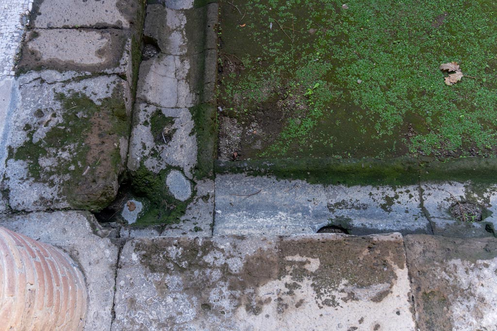 Villa of Mysteries, Pompeii. October 2023.
Looking towards north-east corner of impluvium, with gutter. Photo courtesy of Johannes Eber.