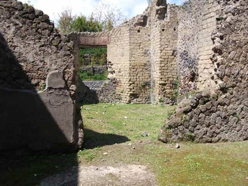 Villa of Mysteries, Pompeii. May 2010. Room 25, apsidal hall, from room 26.
Boyce said that Maiuri suggested this room of curious shape with an apse in the side opposite the entrance doorway, and four rectangular niches in the walls was undergoing renovation at the time of the eruption. Maiuri thought it may have been intended as a domestic Sacellum, and possibly would have housed the statue of Livia found nearby in the peristyle.
See Boyce G. K., 1937. Corpus of the Lararia of Pompeii. Rome: MAAR 14. (p. 98)
See Maiuri, Villa dei Misteri, (76 and fig.29)