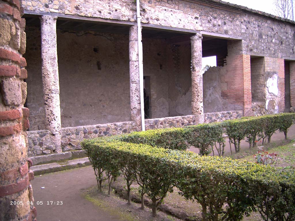 Villa of Mysteries, Pompeii. April 2005. The viridarium in the north-west corner. Looking south-west along the north portico of the garden.
Photo courtesy of Klaus Heese.