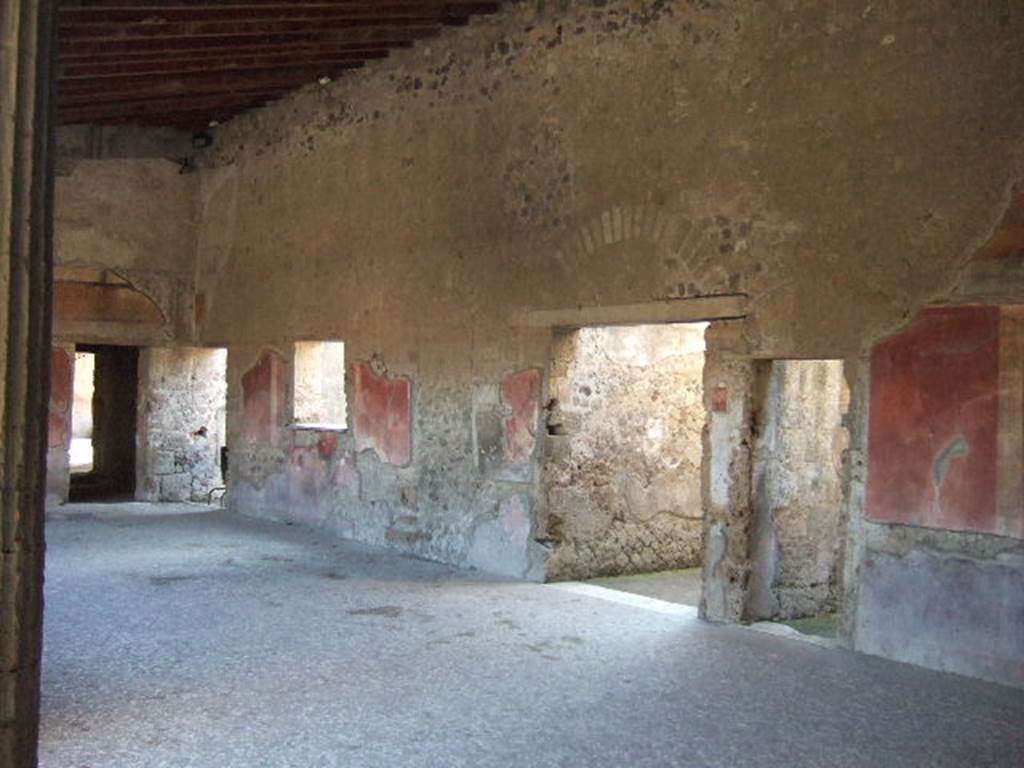 Villa of Mysteries, Pompeii. May 2006.
Doorways to rooms 21, 26, corridor 27 leading towards the wine-making area, and room 28 on peristyle D. Looking north-west.