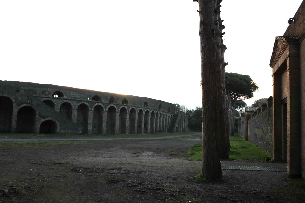 Piazzale Anfiteatro, December 2018.
Looking south from II.7.5, Amphitheatre on left, Grand Palaestra, on right. Photo courtesy of Aude Durand.