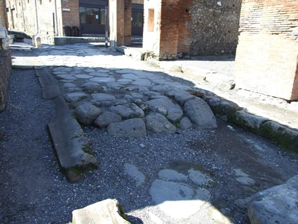 Via degli Augustali between VII.9 and VII.4. March 2009. Looking west to Via del Foro and Forum arch.