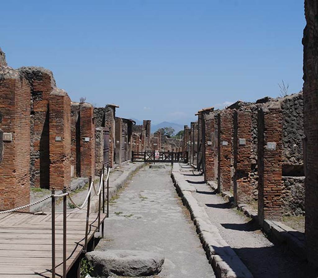 Via degli Augustali, July 2012. Looking east from near VII.4.18, on the left, and VII.9.14, on the right. Photo courtesy of John Vanko. His father took the identical photo in February 1952, see below.