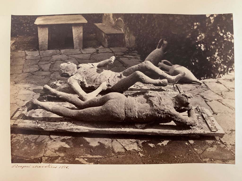 Via del Vesuvio, Pompeii. Album by M. Amodio, c.1880, entitled “Pompei, destroyed on 23 November 79, discovered in 1748”.
These fugitives were found in the middle of the Via del Vesuvio (Via Stabiana) at about a height of four metres from the ancient street level, near the north-eastern corner of Reg. VI.14. Photo courtesy of Rick Bauer.