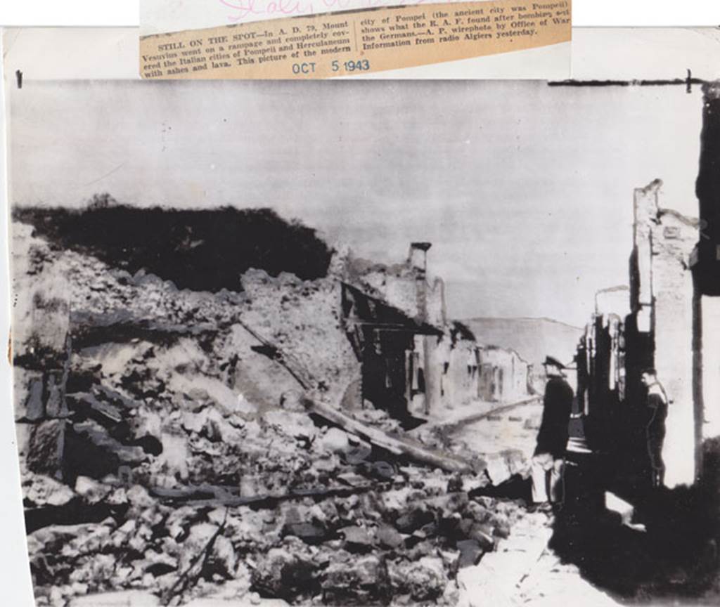 Via dell’Abbondanza Pompeii. October 1943. Looking east between IX.12 and I.8.
Picture that according to the newspaper report “shows what the RAF found after bombing.....”. The destroyed Houses of the Cenacoli Colonnati, following the aerial bombardment of 1943. Photo courtesy of Drew Baker.
The left pilaster of the front façade of IX.12.1 can be seen on the left.