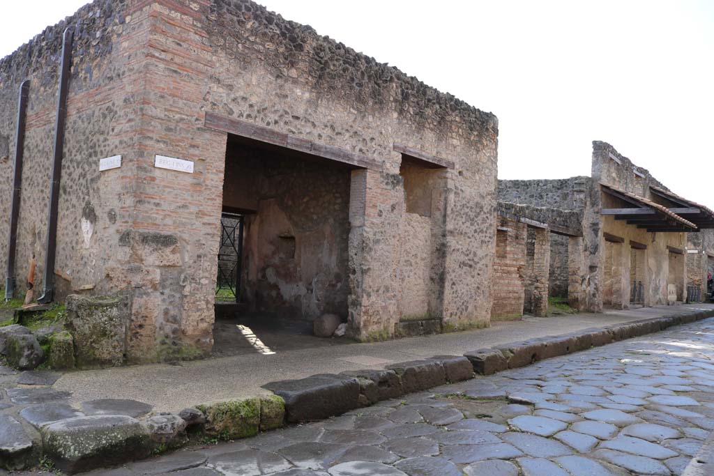 Via dell’Abbondanza, south side. December 2018.
Looking south-west from junction with Vicolo della Nave Europa, on left, towards doorways to I.11.7 to I.11.1, on right.
Photo courtesy of Aude Durand.