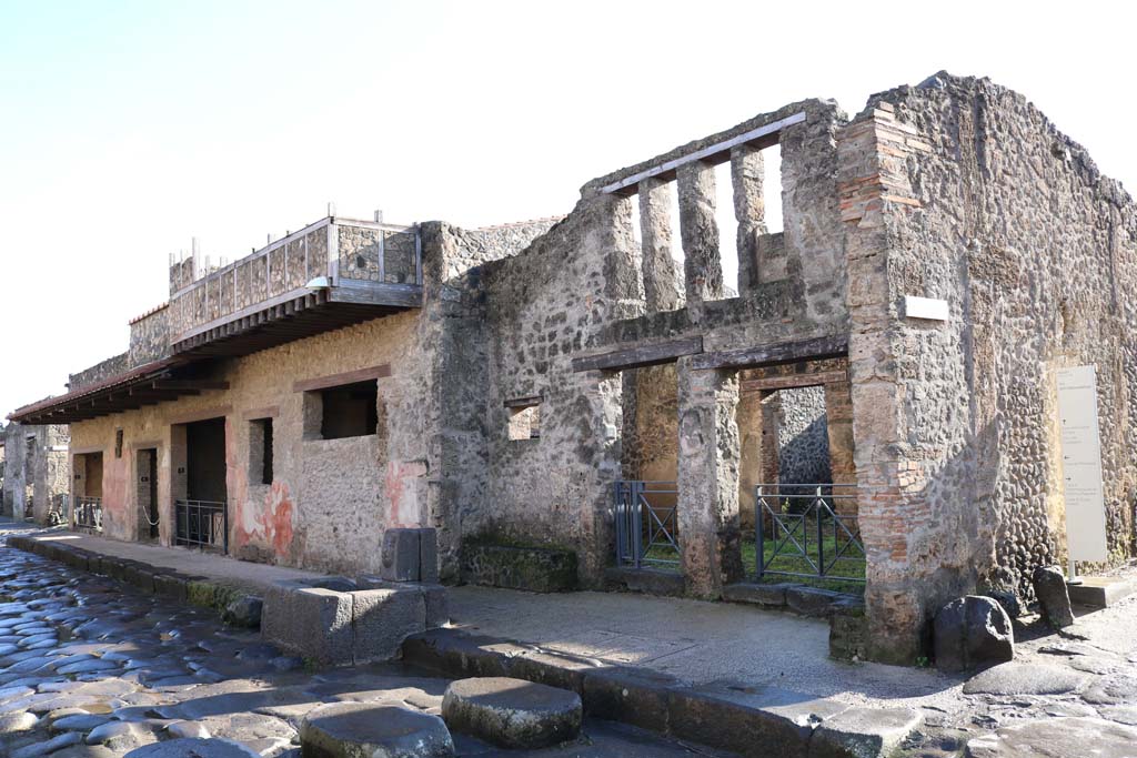 Via dell’Abbondanza, south side. December 2018.
I.12.5, on left, I.12.1, on right. Looking east along south side. Photo courtesy of Aude Durand.