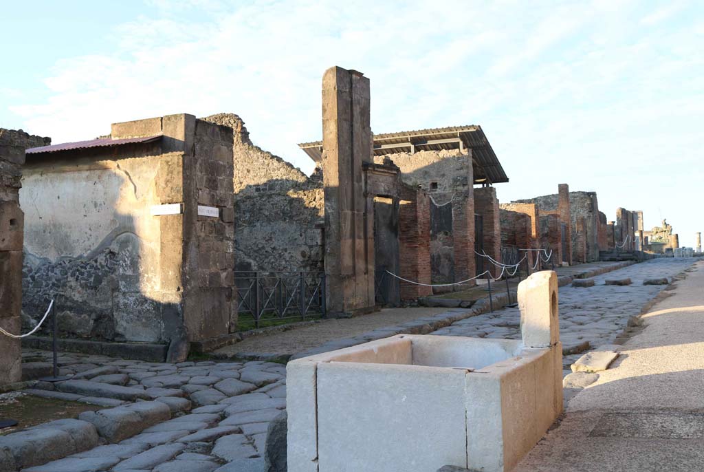 Via dell’Abbondanza, south side, Pompeii. December 2018.
Looking south-west across fountain at VII.9.67/68, towards north side of Insula VIII.3. Photo courtesy of Aude Durand.