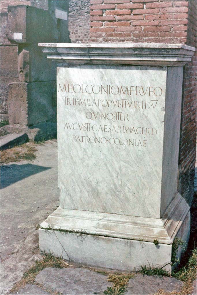 Via dell’Abbondanza, north side, Pompeii. June 1962.
Statue base of Holconius Rufus near VII.1.11.
Photo by Brian Philp: Pictorial Colour Slides, forwarded by Peter Woods
(P43.18 POMPEII STREET INSCRIPTION)