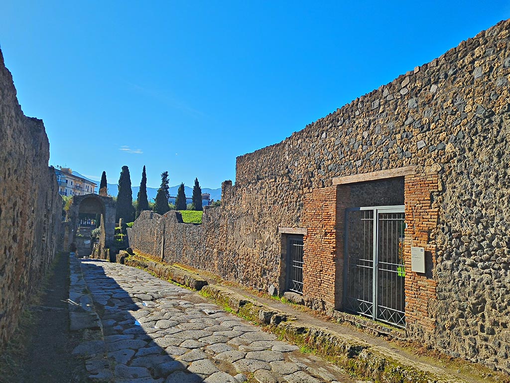 Via di Nocera, Pompeii, west side. October 2024.
Looking south-west towards small doorway to I.20.1, in centre, and I.20.2, on right. Photo courtesy of Giuseppe Ciaramella.