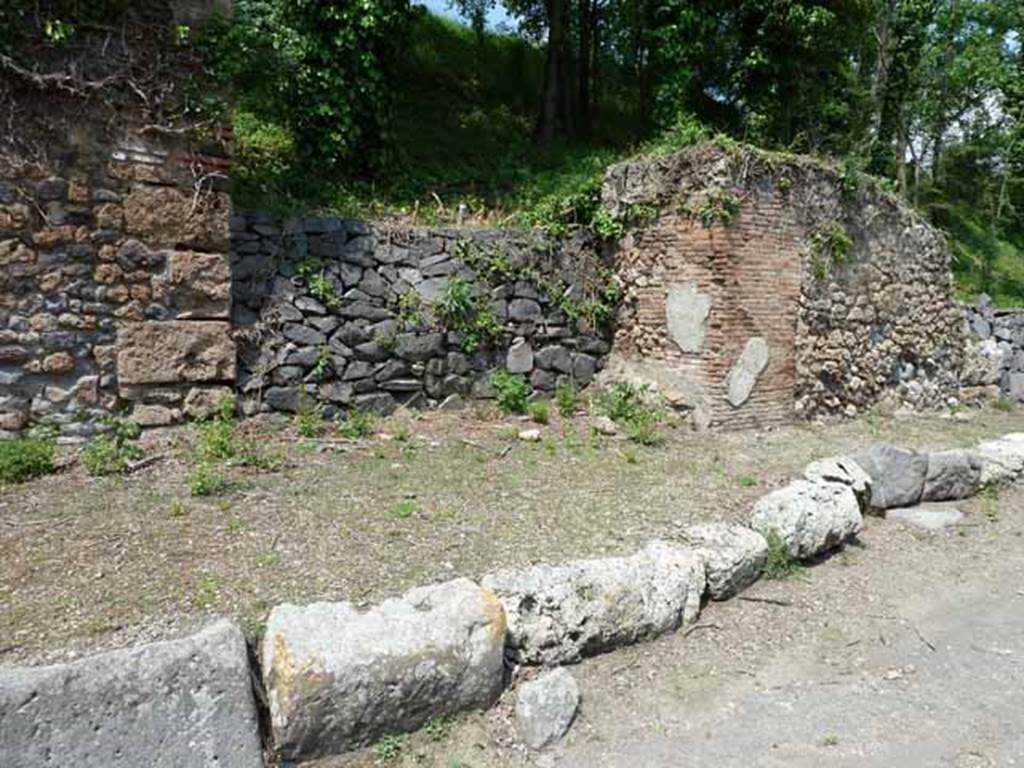 Via di Nola, north side, May 2010. Looking north between IV.4 and IV.5, unexcavated, unnamed vicolo.