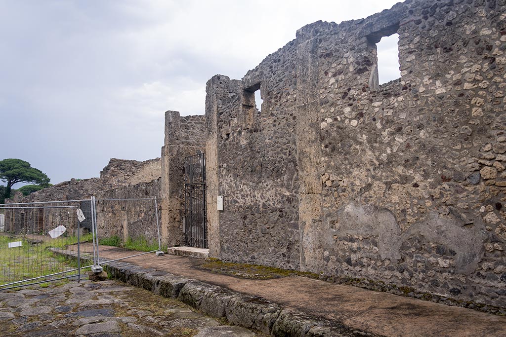 Via di Nola, south side, Pompeii. July 2024.
Looking east along front façade towards entrance doorway of IX.14.4. Photo courtesy of Johannes Eber.