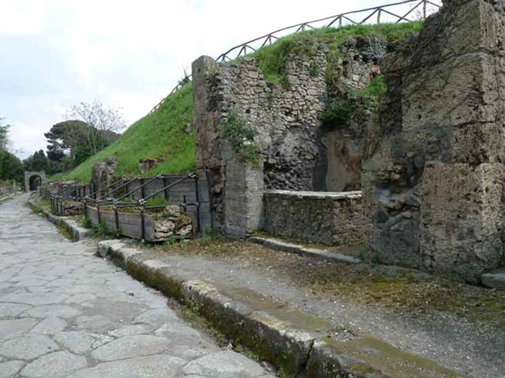 Via di Nola, south side, May 2010. Looking east from III.8.8, towards unexcavated roadway between III.9 and III.8.
