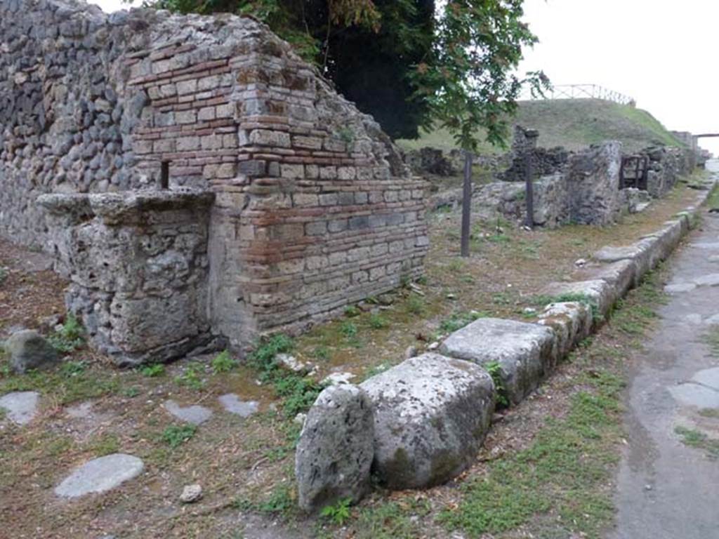 Via di Nola, south side, September 2011. Looking west towards unexcavated vicolo with street altar, on left, and III.10.6 on right. Photo courtesy of Michael Binns.