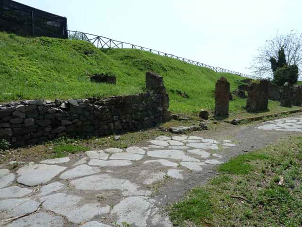 Via di Nola, south side, May 2010. Looking west along site of III.12 (behind modern wall) and III.11.