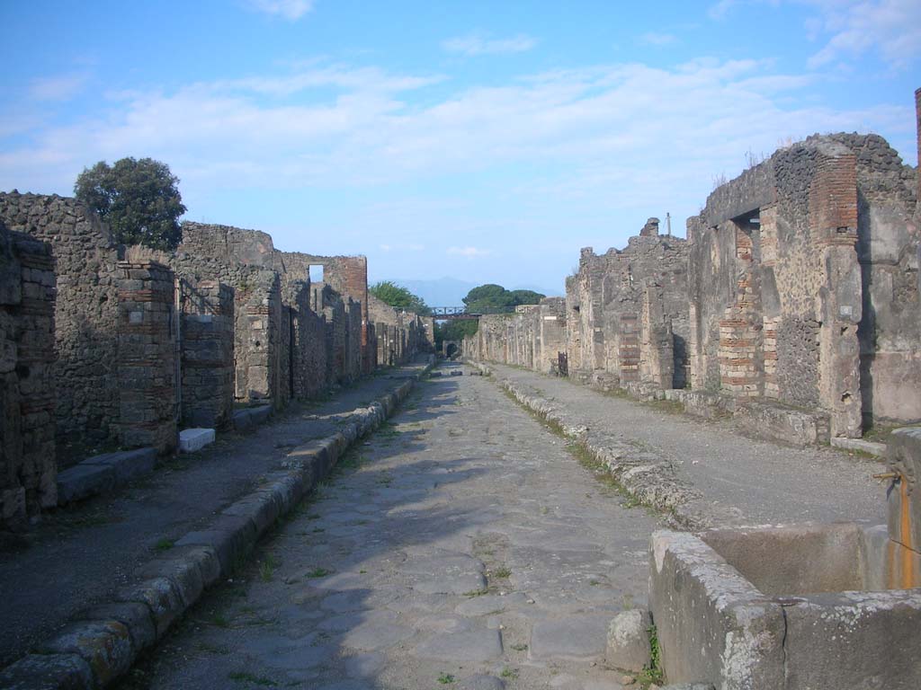 Via di Nola, Pompeii. May 2010.
Looking east between V.3 and IX.8 along roadway towards Nola Gate. Photo courtesy of Ivo van der Graaff.