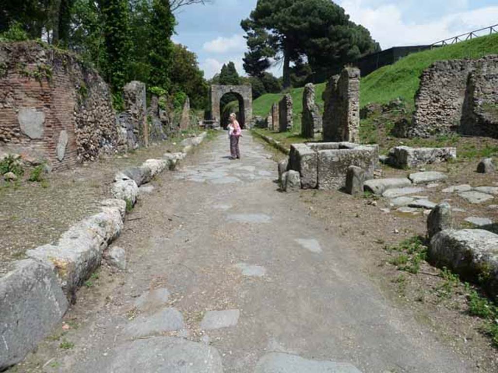 Via di Nola, May 2010. Looking east between IV.5 and III.11, from crossroads with unexcavated unnamed vicoli.