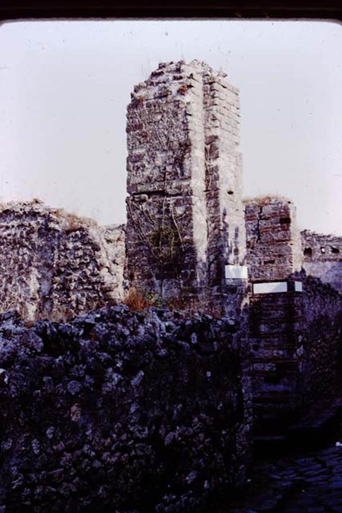 Vicolo dei Dodici Dei, Pompeii. 1980. Looking south to junction with Vicolo della Parete Rossa, and water tower/castle on corner of VIII.5. Photo by Stanley A. Jashemski.
Source: The Wilhelmina and Stanley A. Jashemski archive in the University of Maryland Library, Special Collections (See collection page) and made available under the Creative Commons Attribution-Non Commercial License v.4. See Licence and use details. J80f0218