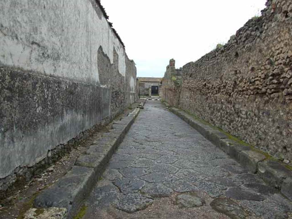 Vicolo del Fauno. May 2010. Looking south between VI.12 and VI.10. from near VI.10.16.