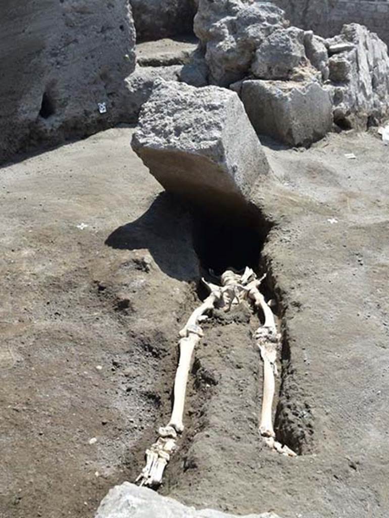 In 2018 at the intersection of the Vicolo delle Nozze d’Argento with the Vicolo c.d. dei Balconi the headless skeleton of a male victim was found.
From the first observations, the individual who survived the early stages of the volcanic eruption, ventured in search of escape along the vicolo now filled by a thick blanket of lapilli.
The body was in fact found at the height of the first floor of the adjacent building, above the lapilli layer.
He was originally thought to have been killed by a large stone block, possibly a door jamb.
The skull of this man was found later at a lower level than the rest of his body, having been displaced by the collapse of a Bourbon tunnel below.
The skull itself suggests that he was not, as first thought, crushed to death by the block but rather asphyxiated during the pyroclastic flow that threw him backwards.
He had with him at least 20 silver and 2 bronze coins, contained in a small purse.
Between the ribs were found the first three coins, and gradually, on removing the remains of the victim, now transferred to the Laboratory of applied research of the archaeological Park of Pompeii, for the continuation of investigations, the remainder were found.
At first glance there would seem to be at least 20 silver denarii and two bronze asses with a nominal value of eighty sesterces and a half.
Such a quantity of coins could at that time guarantee the maintenance of a family of three for 14 to 16 days.
The coins have a very varied chronology. It was possible to examine 15 coins, for the most Republican, starting from mid-2nd century BC.
One of the later Republican coins, is a Legionary Denarius of Mark Antony, common in Pompeii, with the indication of the XXI legion.
Among the few identified imperial coins, a probable denarius of Octavian Augustus and two denarii of Vespasian.
Photograph © Parco Archeologico di Pompei.