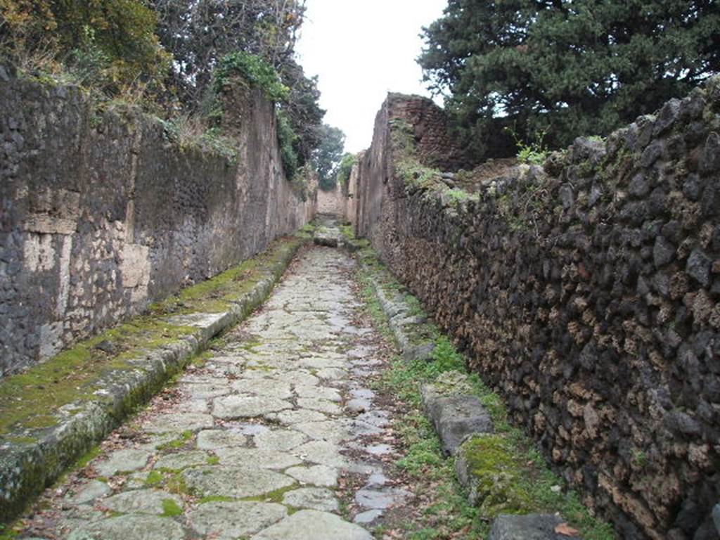 Vicolo delle Pareti Rosse between VIII.6 and VIII.4. Looking west from the junction with Via dei Teatri. December 2004.
