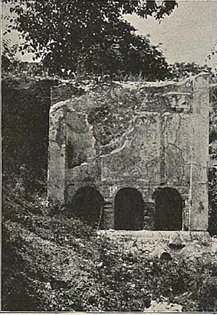 FP3 Pompeii. Detail from late 19th century photo.
The tomb has a vaulted sepulchral chamber entered from the rear.
On the inside of the wall next to the street were three niches. Each niche contained an urn.
Directly over the inner niches, and opening to the street, are three other niches (seen in this photo).
Each had a libation tube allowing relatives to pour oil and wine on to the urns inside.
Lava bust stones, one with the appearance of a woman, were placed at the back of the three outer niches.
See Mau, A., 1907, translated by Kelsey F. W. Pompeii: Its Life and Art. New York: Macmillan. (p. 434-5).