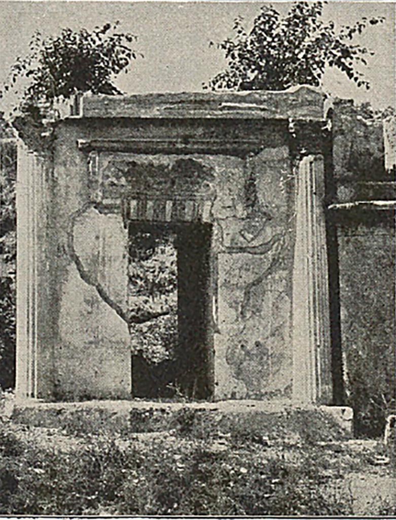 FP4 Pompeii. Detail from late 19th century photo.
According to Mau, the tomb is of interest as showing the result of an attempt to blend the arch type with that of the temple.
A passage roofed with a flat vault runs through the middle of the first storey.
The second story had the appearance of a diminutive temple with four Corinthian columns in front.
The niche representing the cella was of the full width of the tomb and occupied two thirds of the depth; the other third was given to the portico.
Four 1.85m to 2.10m high statues of tufa coated with stucco were found.
Three were statues of men, one an old man, one middle aged and one a youth and the fourth was of a woman.
See Mau, A., 1907, translated by Kelsey F. W. Pompeii: Its Life and Art. New York: Macmillan. (p. 433).
See Mau, A., 1888. Mitteilungen des Kaiserlich Deutschen Archaeologischen Instituts, Roemische Abtheilung Volume III, p. 181.