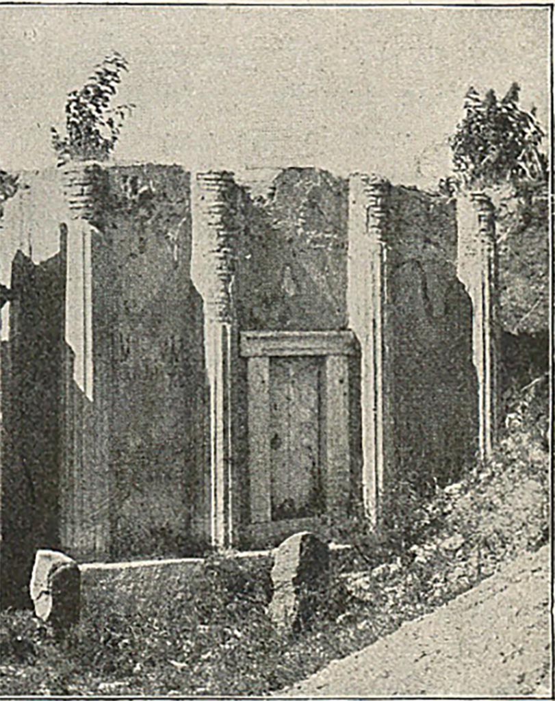 FP6 Pompeii. Detail from late 19th century photo.
According to Mau, “the entrance to the tomb was in front, and closed by a block of travertine.
It led, not to a sepulchral chamber, but to a stairway by which one ascended to the second storey.
Here statues were placed, but the exact form of the upper part cannot be determined.
The finding of five tufa capitals suggests that the second storey may have been a columnar structure, like that of the tomb of the Istacidii.
When the excavations are carried further east enough other fragments will perhaps be found to make a complete restoration possible.
One of the statues is of a man holding a roll of papyrus in his hand, with a round manuscript case, scrinium, at his feet.”
See Mau, A., 1907, translated by Kelsey F. W. Pompeii: Its Life and Art. New York: Macmillan. (p. 435).