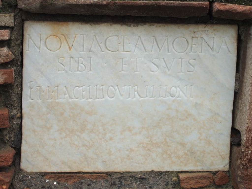 FPNE Pompeii. December 2005. Marble plaque in centre of brick pilaster in tomb.
The inscription reads
NOVIA C. L. AMOENA
SIBI ET SVIS
ET L. IACELLIO VIRILLIONI.
D’Ambrosio and De Caro expand this to:
Novia C(ai) l(iberta) Amoena
sibi et suis
et L(ucio) Iacellio Virillioni
See D’Ambrosio A. and De Caro S., 1988. Römische Gräberstraßen. München: C.H.Beck. p. 208.