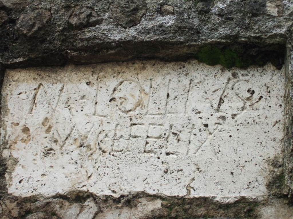 FPNI Pompeii. December 2005. Plaque on west end of south side with inscription:
According to D’Ambrosio and De Caro, this was possibly of non-local travertine and read
M LOLLIVS
M L FELIX
They expand this to
M(arcus) Lollius
M(arci) l(ibertus), Felix
See D’Ambrosio A. and De Caro S., 1988. Römische Gräberstraßen. München: C.H.Beck. p. 214.