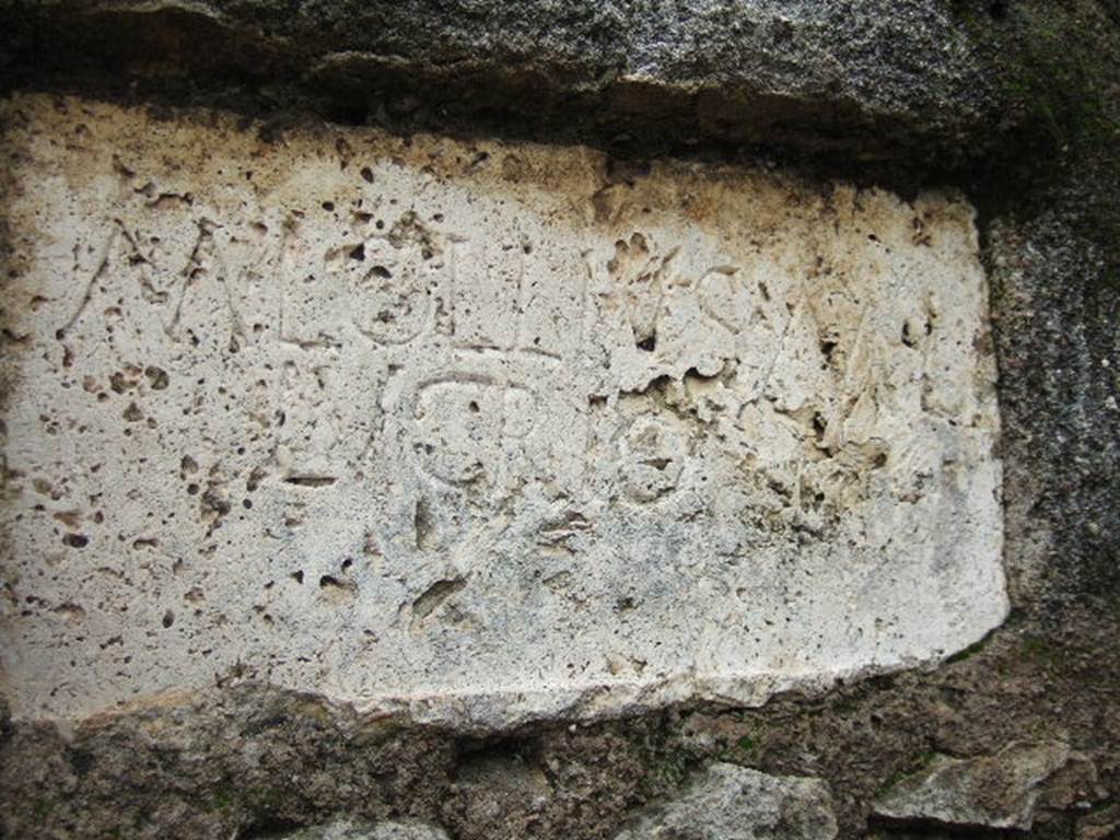 FPNI Pompeii. December 2005. Plaque on east end of south side with inscription:
According to D’Ambrosio and De Caro, this was possibly of non-local travertine and read
M. LOLLIVS M L
LVCRIO.
They expand this to
M(arcus) Lollius M(arci) l(ibertus)
Lucrio
See D’Ambrosio A. and De Caro S., 1988. Römische Gräberstraßen. München: C.H.Beck. p. 214.